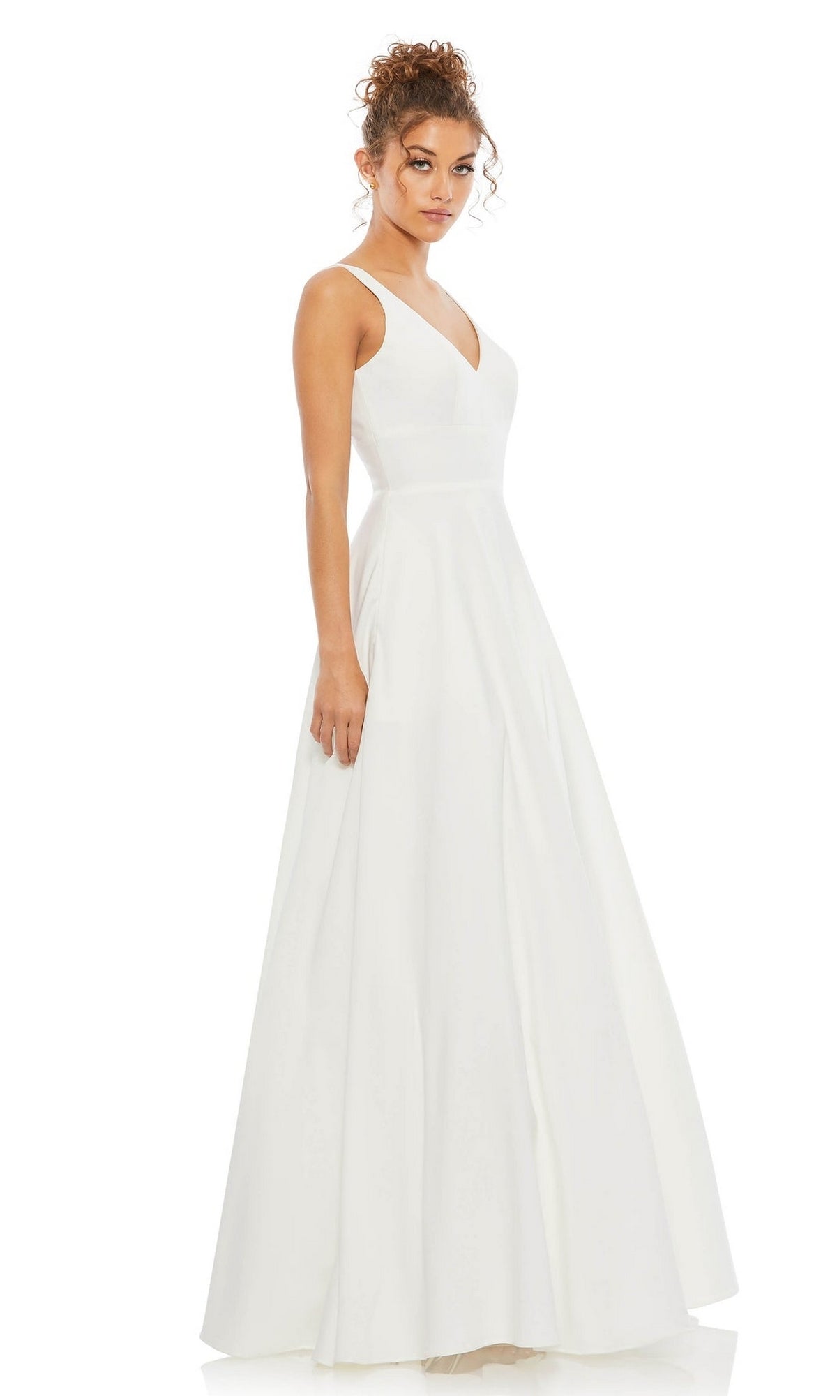 A woman stands against a plain white background wearing the Classic Long Prom Ball Gown: Mac Duggal 48924, featuring a sleeveless, floor-length design with a V-neckline.